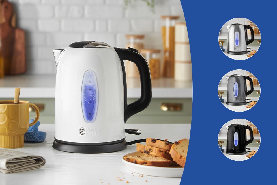 A white Russell Hobbs Worcester jug kettle on a kitchen countertop with other things.